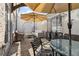Charming outdoor patio features brick flooring, comfortable seating under umbrellas, and stylish outdoor decor at 1241 Hightower Nw Xing, Marietta, GA 30060