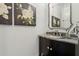 Elegant powder room with dark cabinets, granite counters, and decorative mirror at 1241 Hightower Nw Xing, Marietta, GA 30060