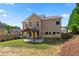 Lovely backyard features a covered patio and a grassy area with a wooden fence and landscaping at 3415 Kenyon Creek Nw Dr, Kennesaw, GA 30152