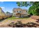 Backyard of home features a covered patio, grassy area, and wooden fence border at 3415 Kenyon Creek Nw Dr, Kennesaw, GA 30152