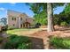 The backyard of this home features a covered patio, grassy area, and a wooded border at 3415 Kenyon Creek Nw Dr, Kennesaw, GA 30152