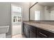 Bathroom features tile floors, a vanity with granite countertop, and a large mirror at 3415 Kenyon Creek Nw Dr, Kennesaw, GA 30152