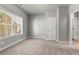 Bright, carpeted bedroom with large window and walk-in closet; freshly painted at 3415 Kenyon Creek Nw Dr, Kennesaw, GA 30152