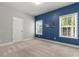 Bedroom with neutral carpet and light gray walls with dark blue accent wall at 3415 Kenyon Creek Nw Dr, Kennesaw, GA 30152
