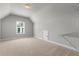 Upstairs bonus room has neutral carpet and walls, plus a window and a small storage closet at 3415 Kenyon Creek Nw Dr, Kennesaw, GA 30152