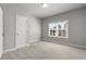 Bedroom featuring neutral carpet, paint and trim, and double-hung window at 3415 Kenyon Creek Nw Dr, Kennesaw, GA 30152