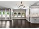 Dining area with hardwood floors and windows overlooking the backyard, adjacent to kitchen at 3415 Kenyon Creek Nw Dr, Kennesaw, GA 30152