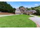 Desirable home featuring stone accents, lush lawn, and a convenient garage, creating a picturesque and inviting curb appeal at 3415 Kenyon Creek Nw Dr, Kennesaw, GA 30152