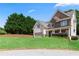 Attractive two-story home boasting a stone facade, well-maintained lawn, and a convenient two-car garage, offering curb appeal at 3415 Kenyon Creek Nw Dr, Kennesaw, GA 30152