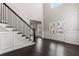 Elegant foyer with wainscoting, staircase, and glass double doors letting in natural light at 3415 Kenyon Creek Nw Dr, Kennesaw, GA 30152