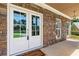 Charming front porch featuring double doors, stone accents, and a cozy welcome mat, creating an inviting entry at 3415 Kenyon Creek Nw Dr, Kennesaw, GA 30152