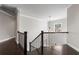Upstairs hallway with decorative railing and modern lighting fixtures overlooking a large window at 3415 Kenyon Creek Nw Dr, Kennesaw, GA 30152