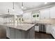 Open-concept kitchen with large island, stainless steel appliances and backyard view at 3415 Kenyon Creek Nw Dr, Kennesaw, GA 30152
