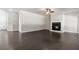 Bright living room with hardwood floors features a cozy fireplace with decorative mantle at 3415 Kenyon Creek Nw Dr, Kennesaw, GA 30152