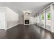 Bright living room featuring fireplace, fan, dark hardwood flooring and large windows at 3415 Kenyon Creek Nw Dr, Kennesaw, GA 30152