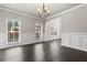 Bright living room with dark hardwood floors, large windows and decorative molding at 3415 Kenyon Creek Nw Dr, Kennesaw, GA 30152