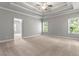 Spacious main bedroom boasts tray ceiling, ceiling fan, and neutral carpeting and walls at 3415 Kenyon Creek Nw Dr, Kennesaw, GA 30152