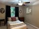 Cozy bedroom featuring a ceiling fan, a comfortable bed, and a window with natural light at 3474 Leaf Land Ct, Duluth, GA 30097
