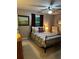 Comfortable bedroom with a wrought iron bed frame, ceiling fan, and a view of the yard at 3474 Leaf Land Ct, Duluth, GA 30097