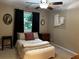 Cozy bedroom featuring a ceiling fan, a comfortable bed, and a window with natural light at 3474 Leaf Land Ct, Duluth, GA 30097