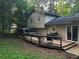 Exterior shot of the home's rear, featuring a large wooden deck and screened-in porch, perfect for outdoor living at 3474 Leaf Land Ct, Duluth, GA 30097