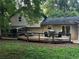 Exterior shot of the home's rear, featuring a large wooden deck and screened-in porch, perfect for outdoor living at 3474 Leaf Land Ct, Duluth, GA 30097