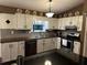 Charming kitchen with white cabinets, gray backsplash, and stainless steel appliances at 3474 Leaf Land Ct, Duluth, GA 30097