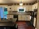 Well-lit kitchen featuring white cabinets, stainless steel appliances, and hardwood floors at 3474 Leaf Land Ct, Duluth, GA 30097