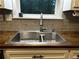 Close-up of the kitchen sink with gray tile backsplash and wood countertops at 3474 Leaf Land Ct, Duluth, GA 30097