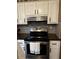Modern kitchen stove with stainless steel appliances and white cabinets at 3474 Leaf Land Ct, Duluth, GA 30097