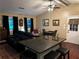 Bright living room featuring a comfortable sofa, hardwood flooring, and a kitchen island with seating at 3474 Leaf Land Ct, Duluth, GA 30097
