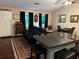 Open-concept living room with hardwood floors, black leather sofa, and island seating at 3474 Leaf Land Ct, Duluth, GA 30097