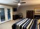 Spacious main bedroom with french doors to an outdoor patio and a dark wood dresser at 3474 Leaf Land Ct, Duluth, GA 30097