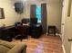 The office space has a large desk, comfortable chair, and neutral laminate flooring at 3474 Leaf Land Ct, Duluth, GA 30097