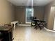Neutral room with tile floor, window overlooking green space, and musical instruments at 3474 Leaf Land Ct, Duluth, GA 30097