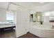 The bathroom features a tub, a shower, and a view of the bedroom and a balcony at 3820 Roswell Ne Rd # 510, Atlanta, GA 30342