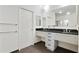 Bathroom featuring a double sink vanity with modern fixtures and black countertops at 3820 Roswell Ne Rd # 510, Atlanta, GA 30342