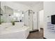 Bathroom featuring a tiled tub, a glass shower, and a mirror at 3820 Roswell Ne Rd # 510, Atlanta, GA 30342