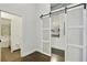 A modern hallway with a barn door leads to the kitchen and bathroom with a tub at 3820 Roswell Ne Rd # 510, Atlanta, GA 30342