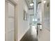 Hallway with white walls and dark wood floors leads to an open kitchen and living area with a balcony at 3820 Roswell Ne Rd # 510, Atlanta, GA 30342