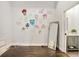 Bright room with vibrant neon art, wood floors, and an open door to the bathroom at 3820 Roswell Ne Rd # 510, Atlanta, GA 30342
