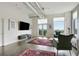 Inviting living room featuring large windows, a television, stylish seating, and access to a balcony with a view at 3820 Roswell Ne Rd # 510, Atlanta, GA 30342