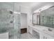 Luxurious bathroom featuring marble tile, a glass shower, and double sink vanity at 7025 Bavarian Wood Pl, Buford, GA 30518