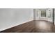 Bedroom featuring hardwood floors, large window, and neutral wall color at 7025 Bavarian Wood Pl, Buford, GA 30518