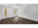Bedroom featuring hardwood floors, ceiling fan, and natural light from large window at 7025 Bavarian Wood Pl, Buford, GA 30518