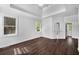 Spacious bedroom featuring dark hardwood floors, white trim and walls and natural light at 7025 Bavarian Wood Pl, Buford, GA 30518