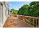 Spacious wooden deck overlooking lush backyard surrounded by mature trees at 7025 Bavarian Wood Pl, Buford, GA 30518