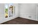 Dining room features dark floors, detailed wall trim, and large windows for natural light at 7025 Bavarian Wood Pl, Buford, GA 30518