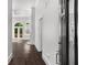Bright foyer with hardwood floors leading to a spacious living area with french doors at 7025 Bavarian Wood Pl, Buford, GA 30518