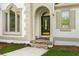 Close-up of front door with elegant stone entrance and arched window features at 7025 Bavarian Wood Pl, Buford, GA 30518